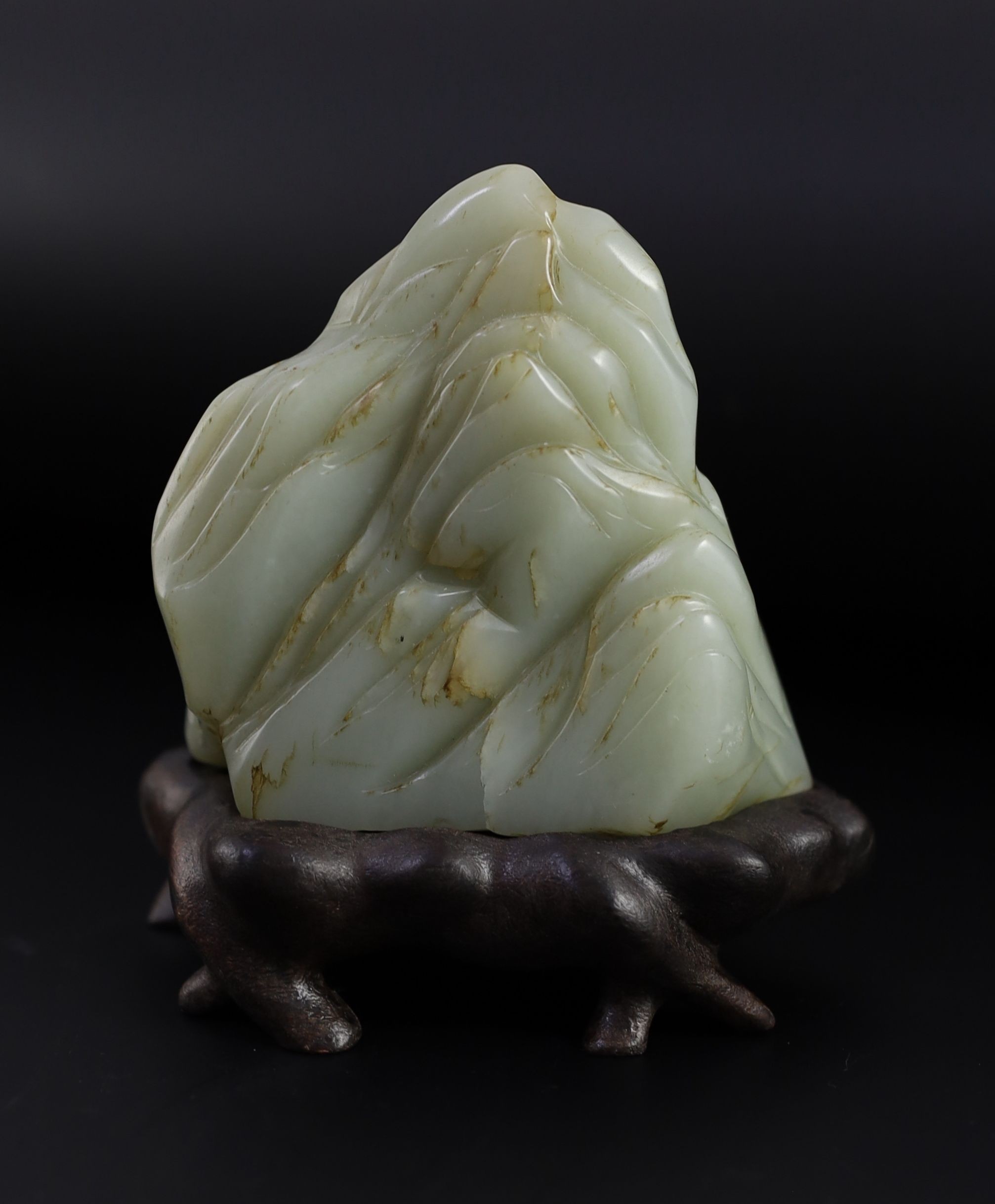 A Chinese pale celadon jade ‘Sanqing’ boulder carving, 18th century, 9.5cm high, 12 with wood stand